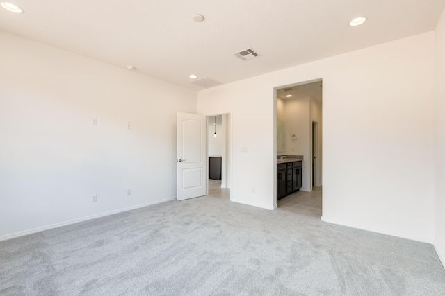 6791 Sydney Dr NE, Rio Rancho, NM 87144 - unfurnished bedroom with light carpet, recessed lighting, baseboards, and ensuite bathroom