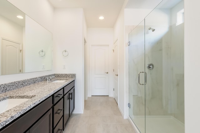 6791 Sydney Dr NE, Rio Rancho, NM 87144 - bathroom featuring a marble finish shower, tile patterned floors, double vanity, baseboards, and recessed lighting