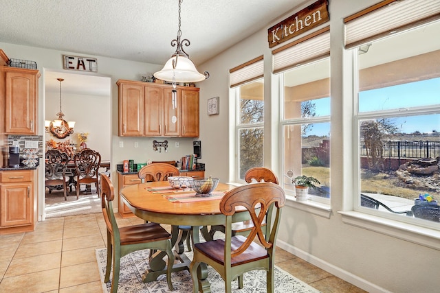 15 Los Miradores Dr NE, Rio Rancho, NM 87124 - dining area featuring light tile patterned flooring, a chandelier, and a textured ceiling