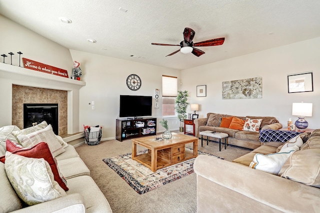15 Los Miradores Dr NE, Rio Rancho, NM 87124 - carpeted living room featuring a ceiling fan, a tile fireplace, baseboards, and a textured ceiling