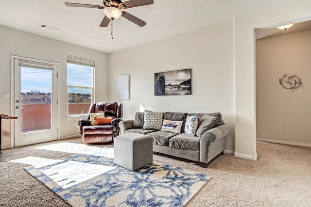 15 Los Miradores Dr NE, Rio Rancho, NM 87124 - carpeted living room with a ceiling fan and baseboards