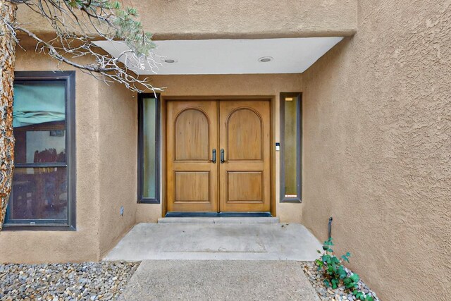 13108 Della Longa Ln NE, Albuquerque, NM 87111 - doorway to property with stucco siding