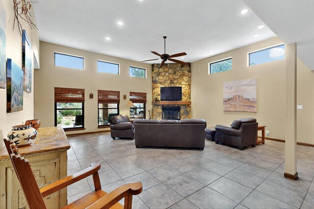 13108 Della Longa Ln NE, Albuquerque, NM 87111 - living room with a ceiling fan, recessed lighting, light tile patterned floors, a fireplace, and baseboards