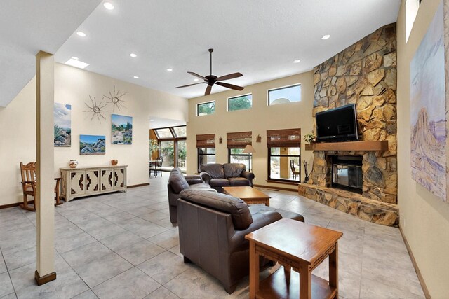 13108 Della Longa Ln NE, Albuquerque, NM 87111 - living room with recessed lighting, a ceiling fan, a fireplace, baseboards, and light tile patterned flooring