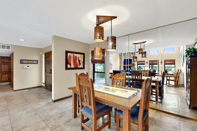 13108 Della Longa Ln NE, Albuquerque, NM 87111 - dining area with healthy amount of natural light, light tile patterned floors, and baseboards