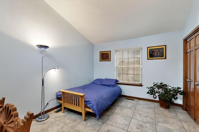 13108 Della Longa Ln NE, Albuquerque, NM 87111 - bedroom featuring lofted ceiling, baseboards, and light tile patterned floors