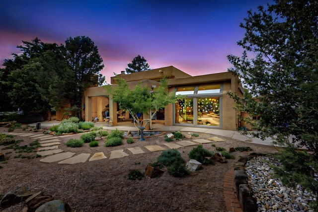 13108 Della Longa Ln NE, Albuquerque, NM 87111 - back of property with a patio area and stucco siding
