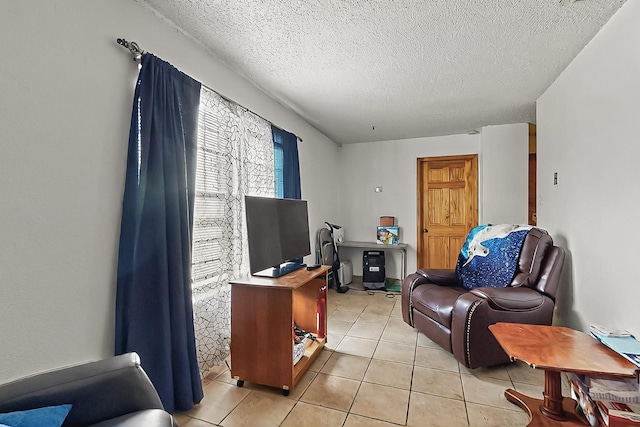 2800 Vail Ave SE Unit D113, Albuquerque, NM 87106 - living room featuring light tile patterned flooring and a textured ceiling
