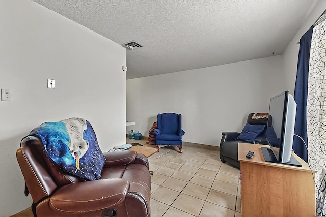 2800 Vail Ave SE Unit D113, Albuquerque, NM 87106 - sitting room featuring light tile patterned flooring and a textured ceiling