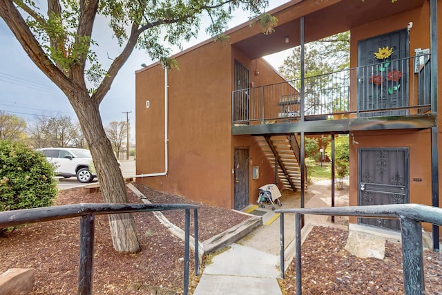 2800 Vail Ave SE Unit D113, Albuquerque, NM 87106 - view of home's exterior featuring stairs and stucco siding