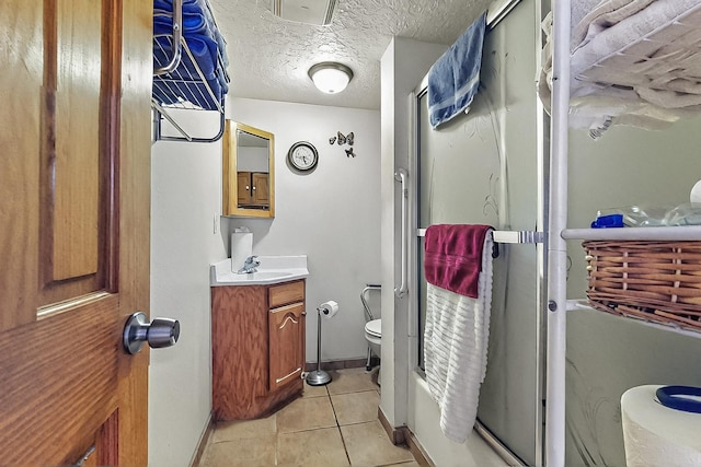 2800 Vail Ave SE Unit D113, Albuquerque, NM 87106 - bathroom with toilet, an enclosed shower, tile patterned floors, vanity, and baseboards