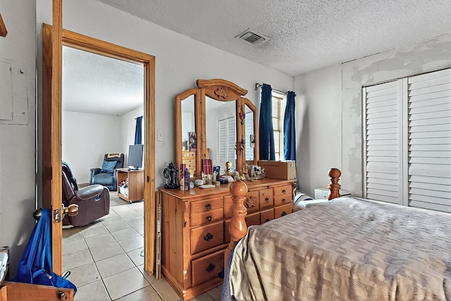 2800 Vail Ave SE Unit D113, Albuquerque, NM 87106 - bedroom with a textured ceiling and light tile patterned flooring