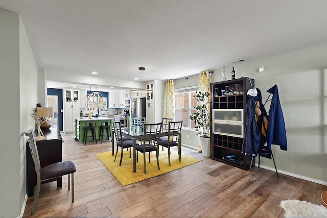 7720 Red Finch Ct NW, Albuquerque, NM 87114 - dining room with light wood-style floors, baseboards, and recessed lighting