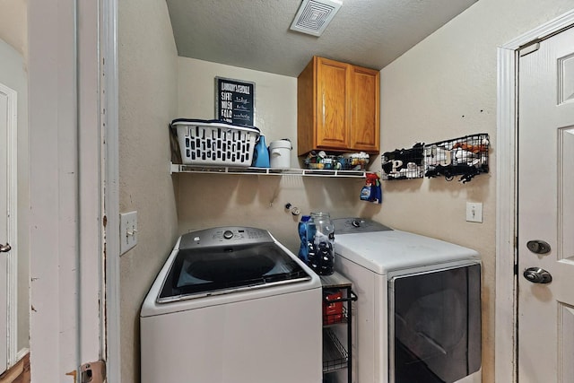 7720 Red Finch Ct NW, Albuquerque, NM 87114 - washroom with washing machine and clothes dryer, cabinet space, and a textured ceiling