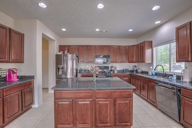 3929 Las Colinas Ave, Rio Rancho, NM 87124 - kitchen featuring appliances with stainless steel finishes, a sink, a center island, recessed lighting, and dark stone countertops