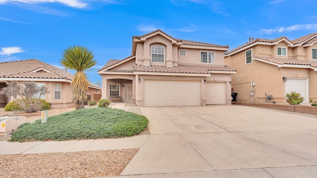 4212 Caprock Rd NW, Albuquerque, NM 87114 - mediterranean / spanish house featuring an attached garage, stucco siding, driveway, and a tiled roof