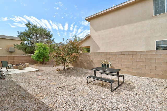 6605 Country Knoll Ct NW, Albuquerque, NM 87114 - fenced backyard with an outdoor fire pit and a patio