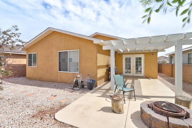 6605 Country Knoll Ct NW, Albuquerque, NM 87114 - back of property featuring french doors, a fire pit, fence, stucco siding, and a pergola