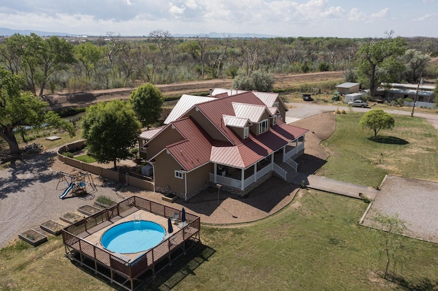 aerial view of property and surrounding area with a pool