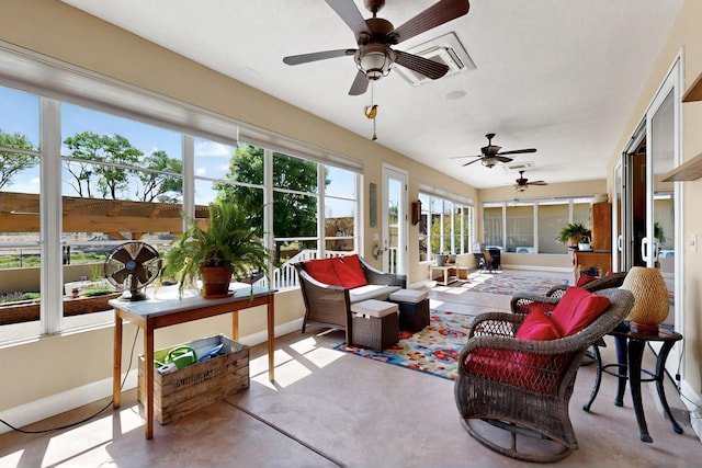 sunroom with baseboards and concrete floors