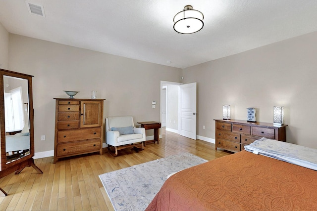 bedroom featuring light wood-type flooring and baseboards