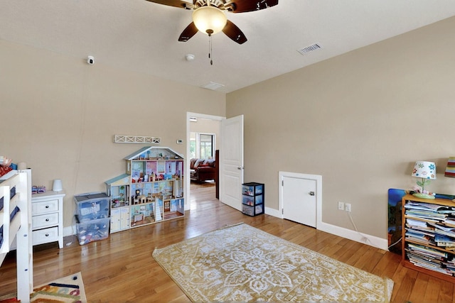 playroom featuring a ceiling fan, wood finished floors, and baseboards