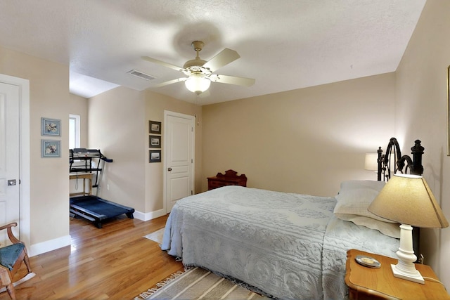 bedroom with wood finished floors, baseboards, and a ceiling fan