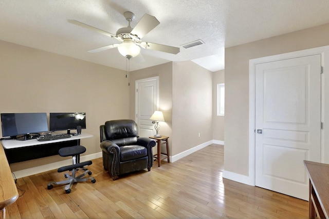 office area featuring baseboards, light wood-style flooring, and ceiling fan