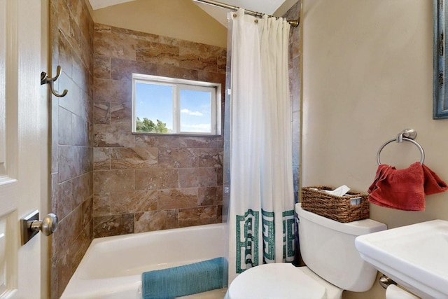 bathroom featuring toilet and shower / bath combination with curtain
