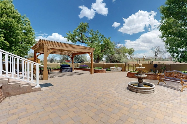 view of patio featuring a pergola and fence