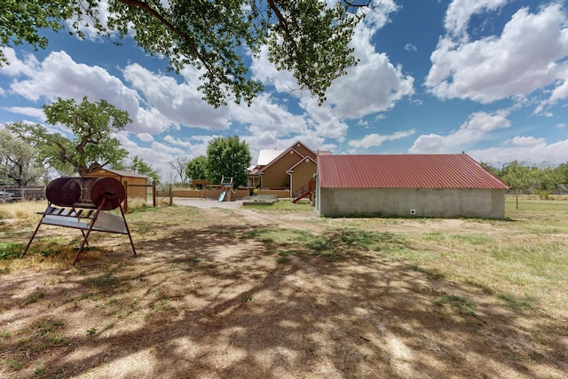 view of yard featuring an outbuilding and fence