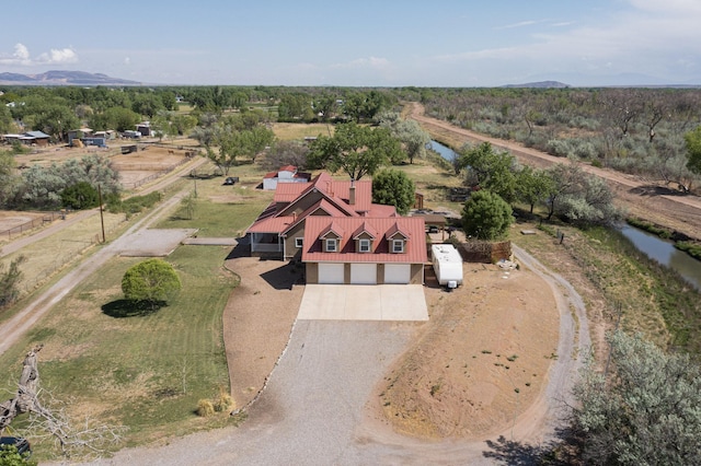 aerial view of property and surrounding area featuring a nearby body of water