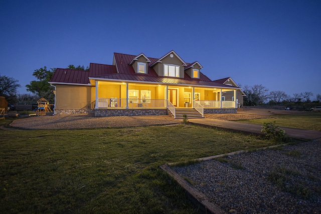 70 Sanchez Rd, Belen, NM 87002 - back of house featuring a porch, a lawn, a standing seam roof, and metal roof