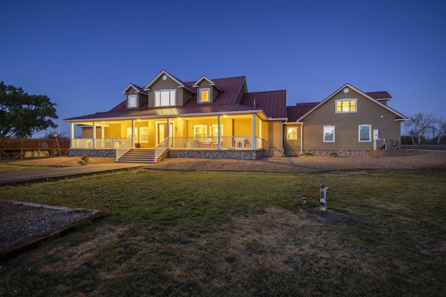 70 Sanchez Rd, Belen, NM 87002 - back of property with a porch, a lawn, a standing seam roof, and metal roof