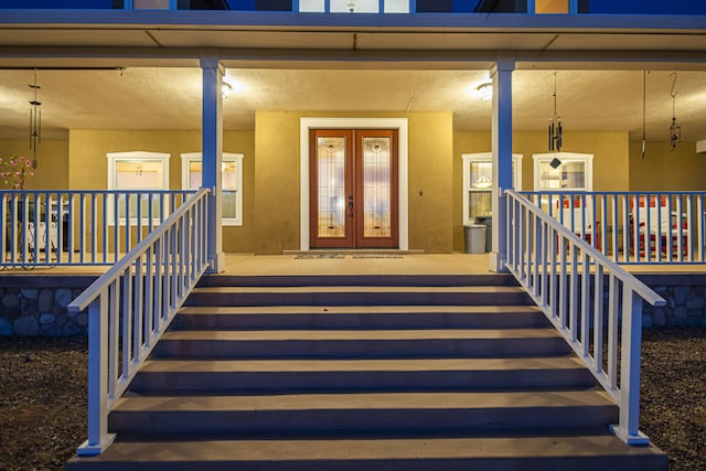 70 Sanchez Rd, Belen, NM 87002 - property entrance with a porch, french doors, and stucco siding