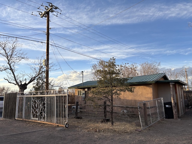 1816 Isleta Blvd SW, Albuquerque, NM 87105 - view of home's exterior featuring a metal roof and a gate