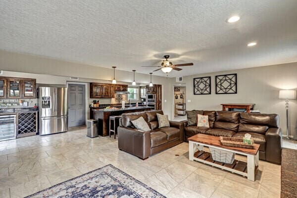6400 Torreon Dr NE, Albuquerque, NM 87109 - living room with ceiling fan, a textured ceiling, and recessed lighting