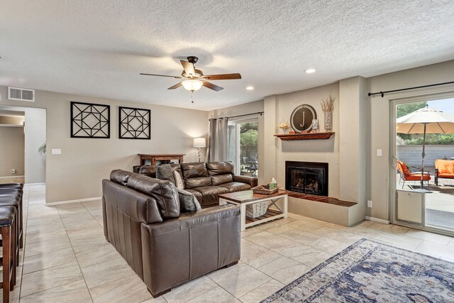 6400 Torreon Dr NE, Albuquerque, NM 87109 - living room with a glass covered fireplace, ceiling fan, healthy amount of natural light, recessed lighting, and baseboards