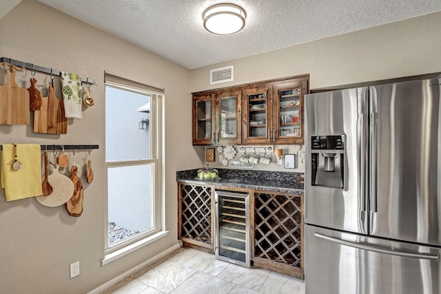 6400 Torreon Dr NE, Albuquerque, NM 87109 - indoor dry bar with stainless steel fridge, wine cooler, a textured ceiling, and baseboards