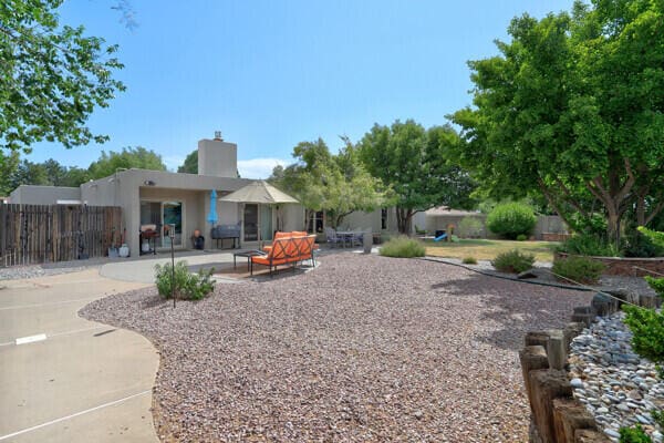 6400 Torreon Dr NE, Albuquerque, NM 87109 - view of yard with a patio, fence, and a playground