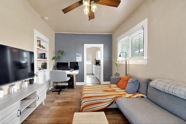 608 Coal Ave SE, Albuquerque, NM 87102 - living room with an office area, wood finished floors, a ceiling fan, and built in shelves