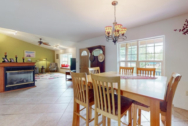 5 Francisco Rd, Cedar Crest, NM 87008 - dining space with light tile patterned floors, a glass covered fireplace, a ceiling fan, a chandelier, and lofted ceiling