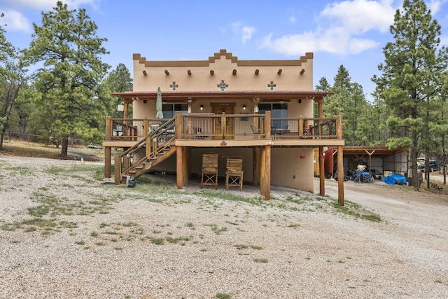 160 Black Bear Rd, Ramah, NM 87321 - back of property with stairs, a wooden deck, and driveway