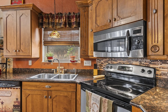 160 Black Bear Rd, Ramah, NM 87321 - kitchen featuring appliances with stainless steel finishes, dark countertops, and brown cabinetry