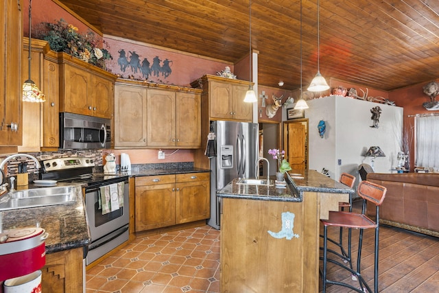 160 Black Bear Rd, Ramah, NM 87321 - kitchen with stainless steel appliances, wooden ceiling, a kitchen bar, a kitchen island with sink, and decorative light fixtures
