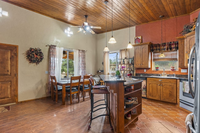 160 Black Bear Rd, Ramah, NM 87321 - kitchen with dark countertops, wood ceiling, open shelves, a textured wall, and plenty of natural light