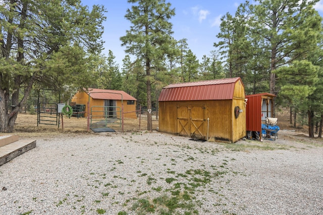 160 Black Bear Rd, Ramah, NM 87321 - view of shed with view of wooded area and a gate
