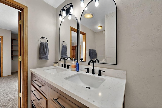 404 Pecos Loop SE, Rio Rancho, NM 87124 - bathroom featuring double vanity and a textured wall