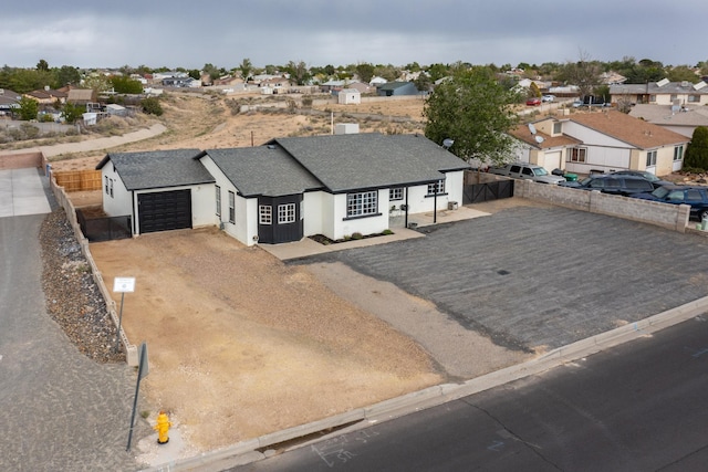 404 Pecos Loop SE, Rio Rancho, NM 87124 - view of front of house featuring a garage, a shingled roof, a residential view, driveway, and stucco siding