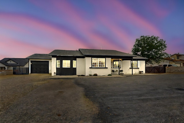 404 Pecos Loop SE, Rio Rancho, NM 87124 - view of front facade with an attached garage, driveway, and stucco siding